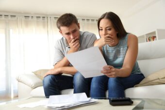 Couple reading a foreclosure document from California