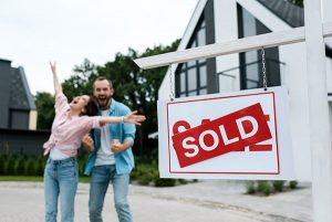 Happy couple celebrating that they sold their ingerited house for quick cash