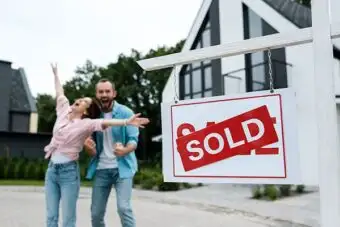 Happy couple celebrating that they sold their ingerited house for quick cash