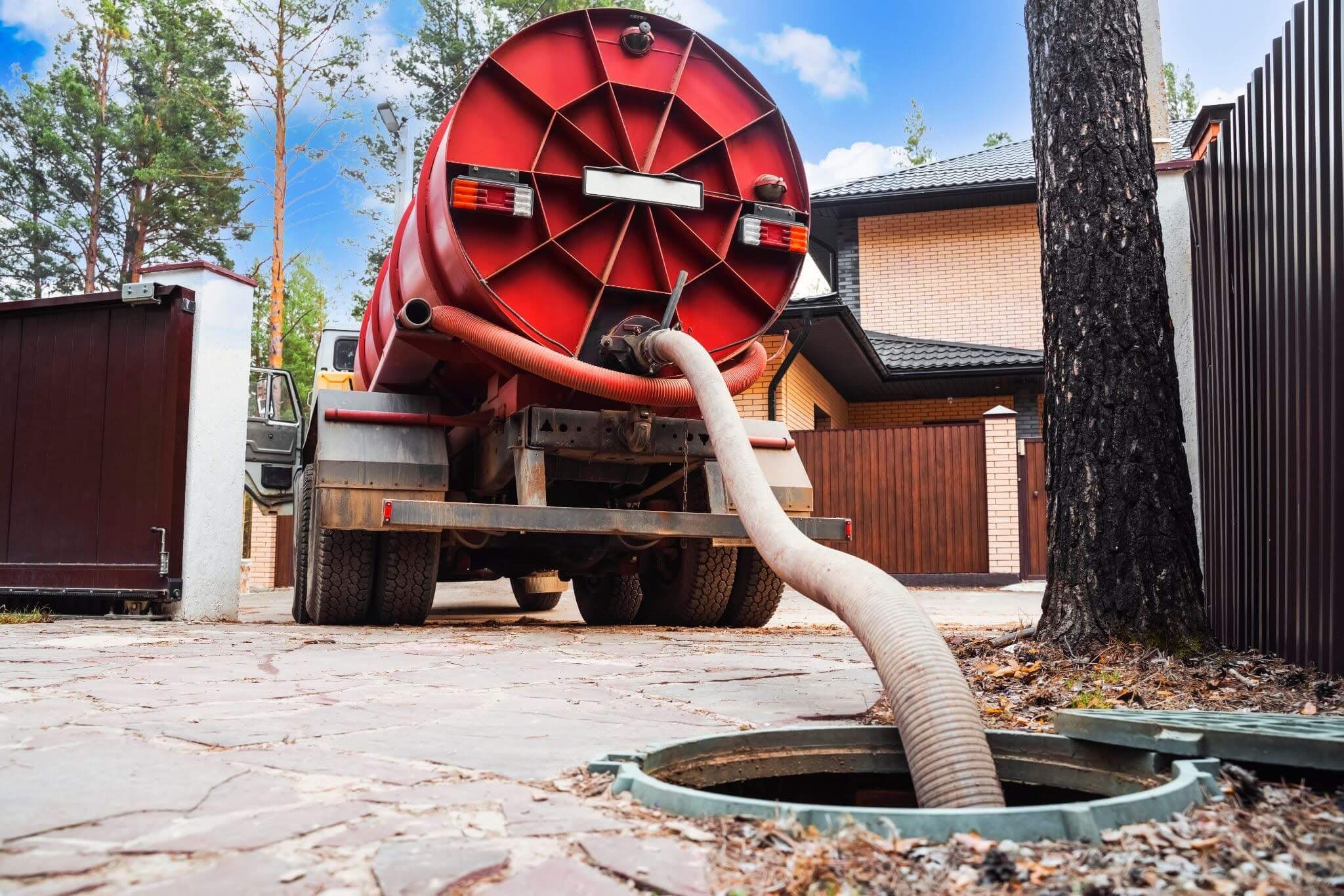 A sewage tank truck pumping sewage from a septic tank