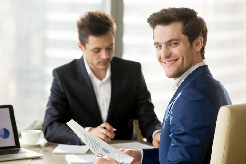Two professionals discussing the benefits of wholesale real estate.