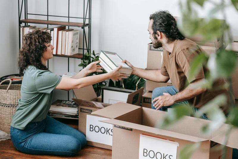 Two people sorting and boxing books after a family death.