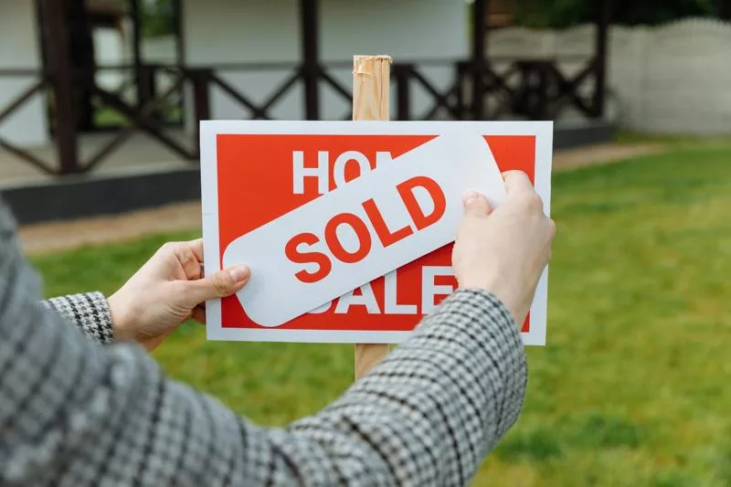 Home sale completed with sold sign placed on listing board.