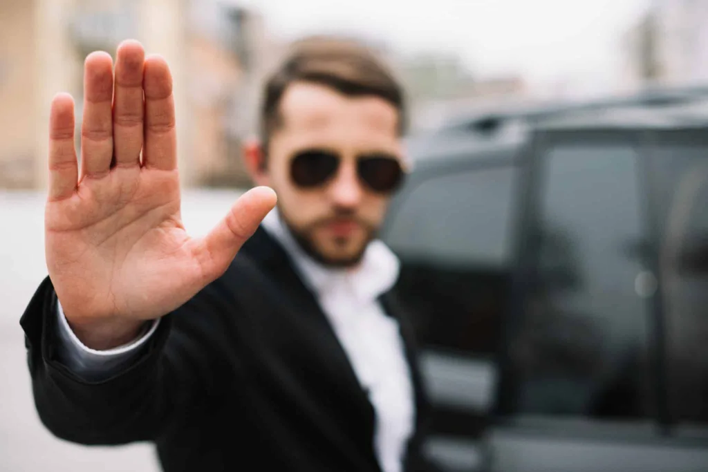 Homeowner holds up hand to block or stop rent-to-own problems.