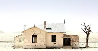 Old condemned house with cracks in California desert