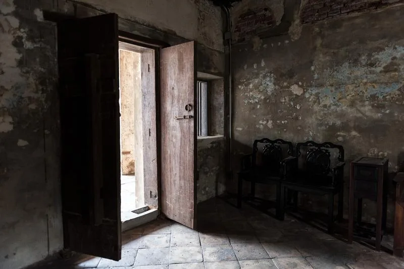 Interior of old deteriorating house showing signs of structural neglect and decay