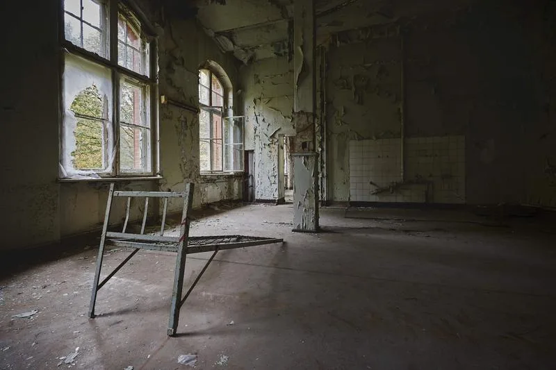 Interior of an old condemned house with broken windows and decay