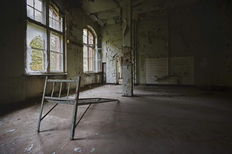 Interior of an old condemned house with broken windows and decay