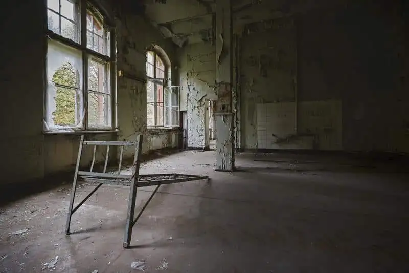 Interior of an old condemned house with broken windows and decay