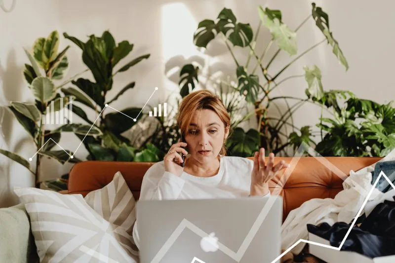 Worried homeowner on phone, discussing house sale delays and frustrations.
