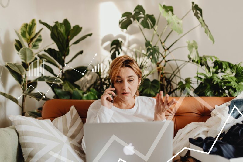 Worried homeowner on phone, discussing house sale delays and frustrations.