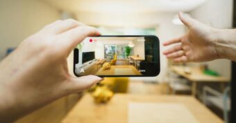 Smartphone capturing a bright living room, taking photos to list the home.