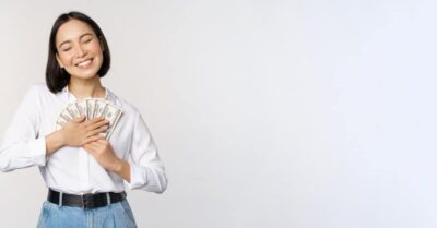 Happy woman holding cash, representing pros and cons of offers