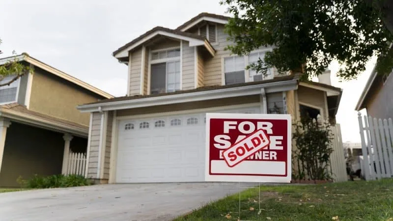 SOLD FSBO sign in front of house
