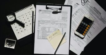 Forms, calendar, and phone calculator showing closing documents.