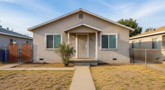 A beige house with white trim that needs repairs in San Bernardino, California