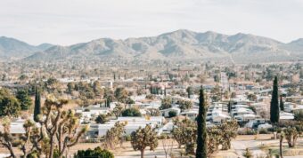 An oblique aerial view of Yucca Valley, California, with desert landscaping and rolling hills in the background.