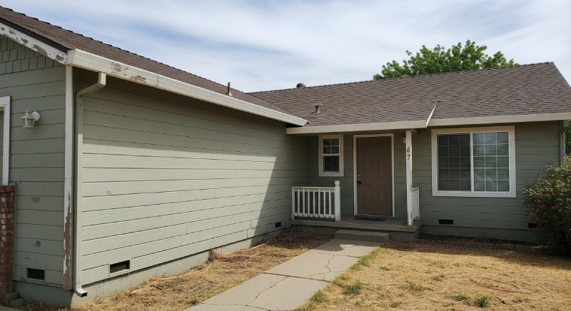Worn Yuba County home with cracked walkway, showing Osborne Homes’ willingness to buy distressed houses.