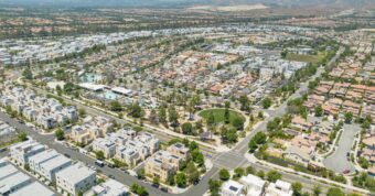 Aerial view of modern Irvine neighborhood development showing planned community housing purchased by cash buyers.