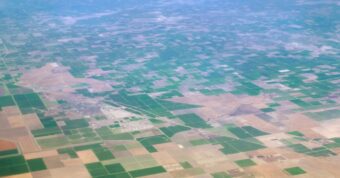 Aerial view of farmland in Kings County, California, showcasing agricultural landscape and regional real estate conditions.