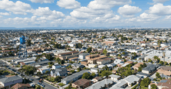 Aerial view of Lynwood, California, residential area showing houses we buy for cash quickly. AI-generated.