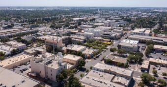 Aerial view of Merced, California, downtown area showing the local real estate market for cash home buyers.