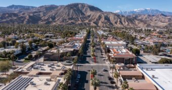 Aerial view of downtown Palm Desert, CA, with a mountain backdrop showing the area that Osborne Homes covers.