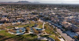 Aerial view of Jurupa Valley suburban neighborhood with park showing Riverside County homes purchased by cash buyers.