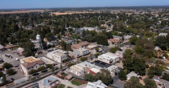 Historic downtown Elk Grove with water tower showing established neighborhoods where cash buyers purchase homes quickly.